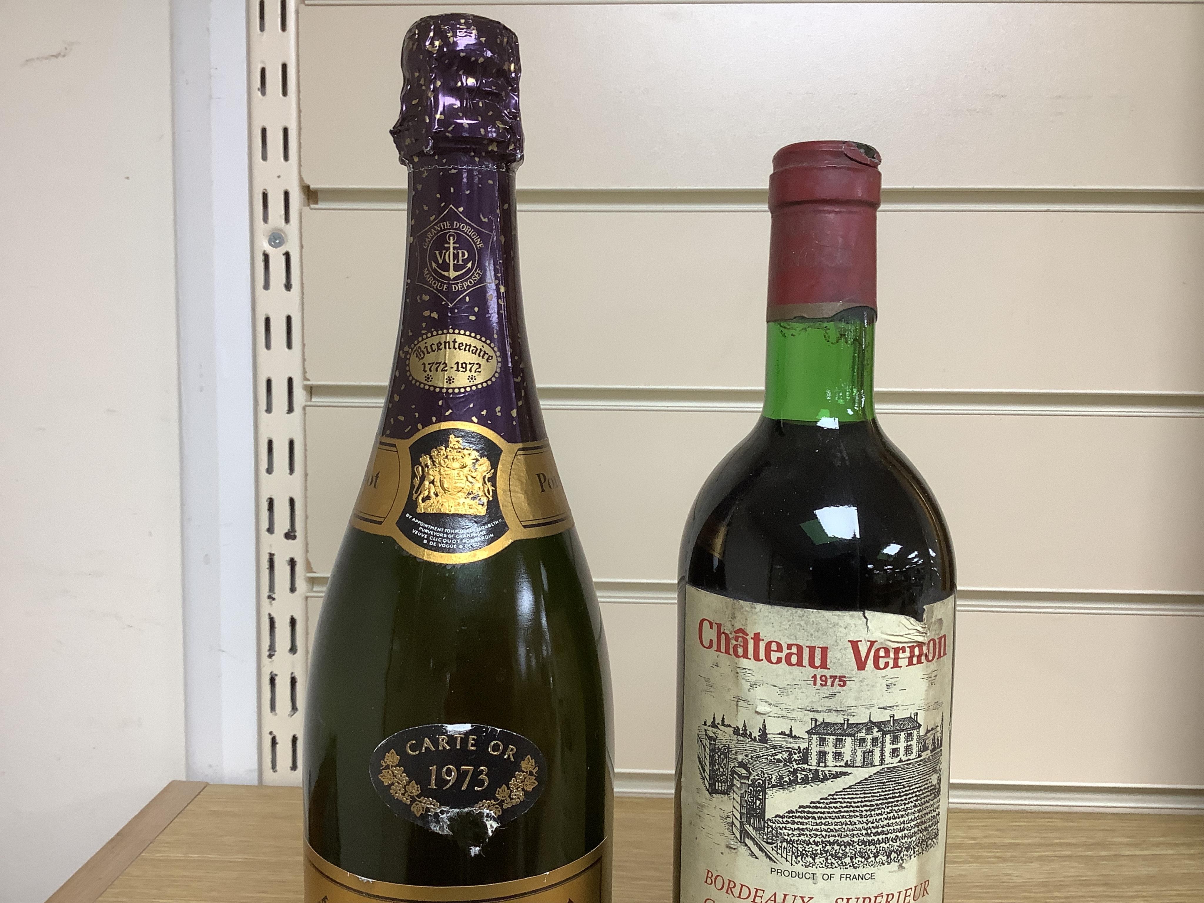 A bottle of 1973 Veuve Clicquot Ponsardin champagne and a bottle of 1975 Chateau Vernon. Condition - fair